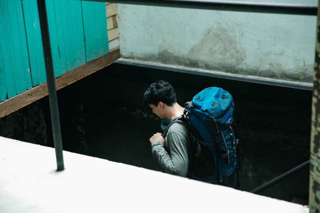 man carrying a blue backpack
