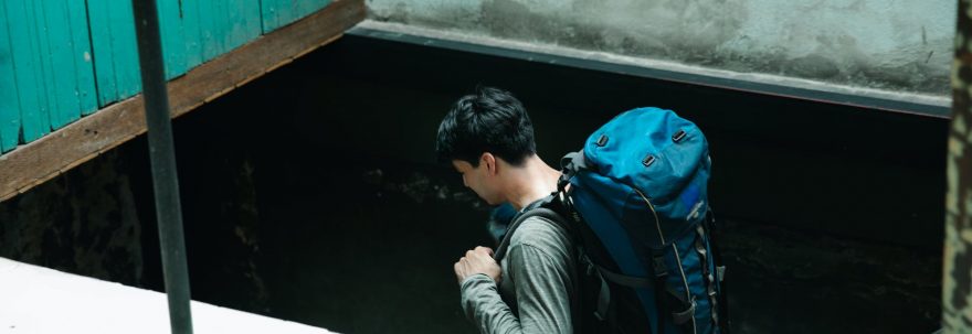 man carrying a blue backpack