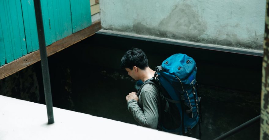 man carrying a blue backpack